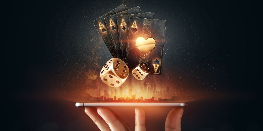 Dream Data Services gambler leads a hand holding up a mobile device with dice and cards above that represent online gambling